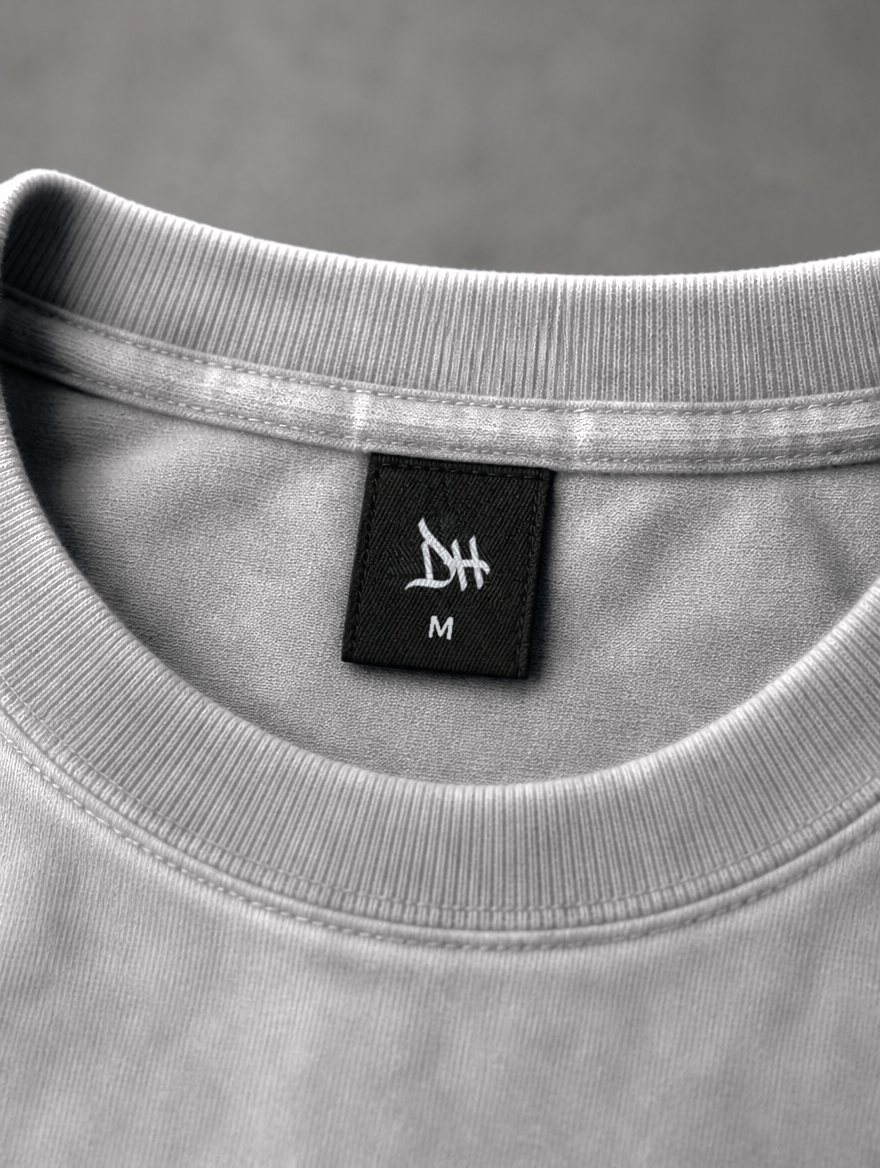Woven DH label with the size beneath it, inside the neck. Concept render.